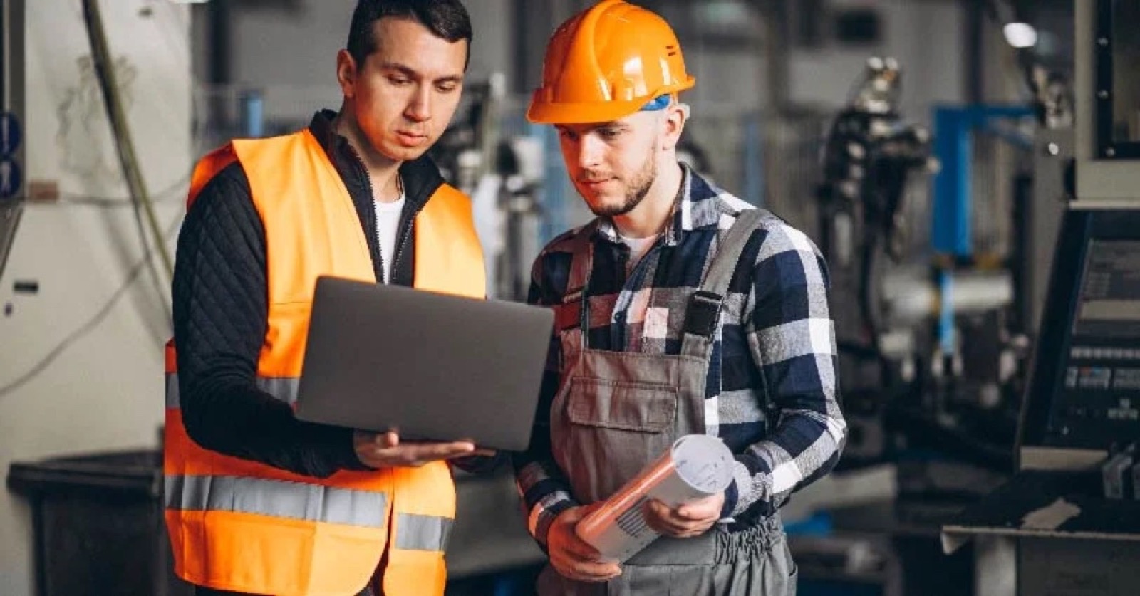 Supervisores en piso industrial con laptop — ERP SAP TM vs agentes que ejecutan el flete